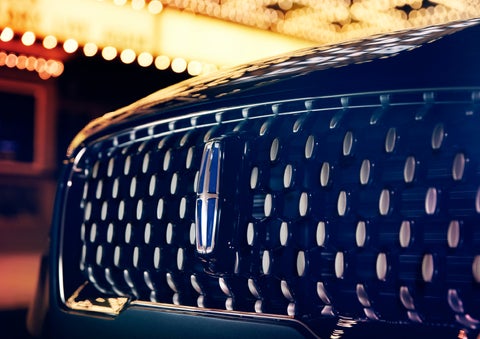 The Corsair Grand Touring grille shows floating chrome ovals that catch the glowing light of a theater marquee and frame the distinctive Lincoln Star | Irwin Lincoln in Freehold NJ