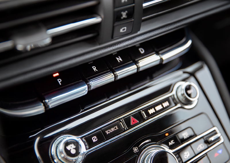 The Park button on the elegant Piano Key Shifter is lit up and engaged as light dances off the chrome accents and horizontal design lines | Irwin Lincoln in Freehold NJ