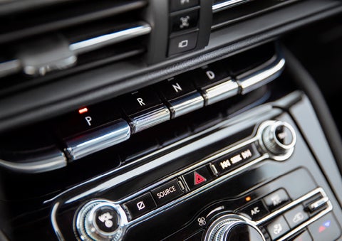 The Park button on the elegant Piano Key Shifter is lit up and engaged as light dances off the chrome accents and horizontal design lines | Irwin Lincoln in Freehold NJ