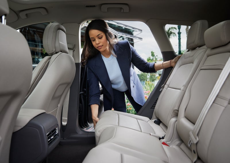 A woman slides the second-row seat forward to create more cargo space | Irwin Lincoln in Freehold NJ
