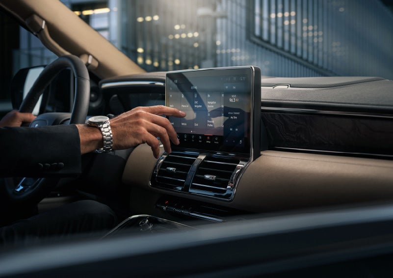 A hand is about to press the personal profiles tile on the settings screen | Irwin Lincoln in Freehold NJ