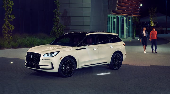 Two people approach a 2024 Lincoln Corsair® SUV featuring the available Jet Appearance Package. | Irwin Lincoln in Freehold NJ