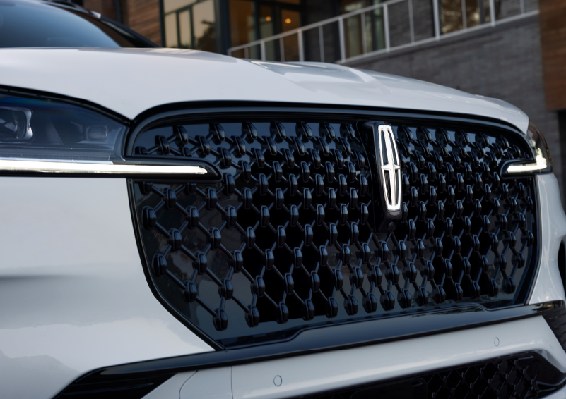 The black grille of a white 2025 Lincoln Aviator® SUV is shown with its fog lights on. | Irwin Lincoln in Freehold NJ