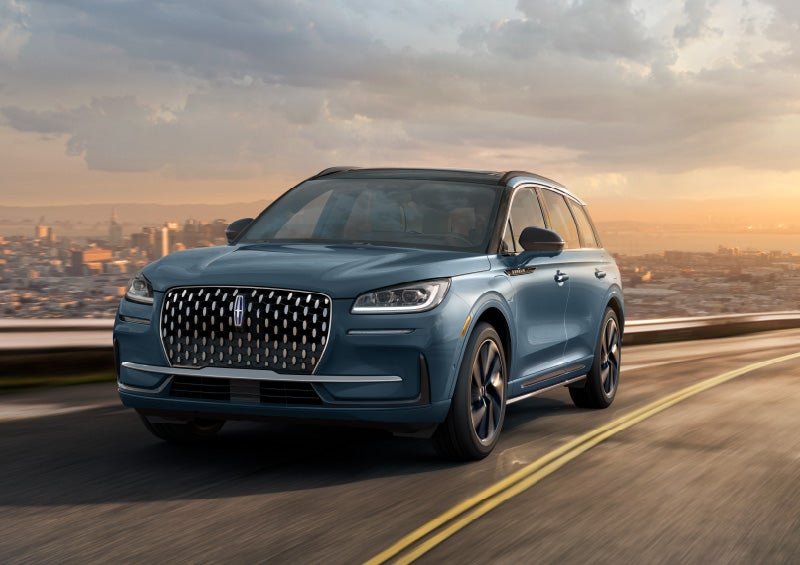 A 2025 Lincoln Corsair® SUV is shown being driven on a city road.