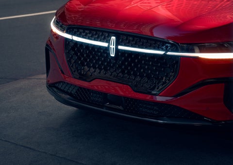 The available front LED light bar and center Lincoln Star logo glow at dusk. | Irwin Lincoln in Freehold NJ