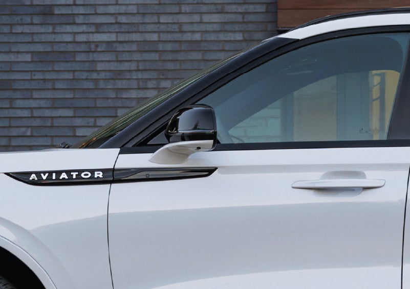 The driver’s side door and fender badging of a white 2026 Lincoln Aviator® SUV are showcased. | Irwin Lincoln in Freehold NJ