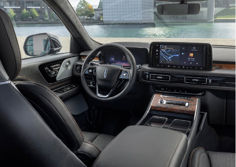 The interior of the 2026 Lincoln Aviator® SUV is shown parked with a view of a harbor through the windshield. | Irwin Lincoln in Freehold NJ