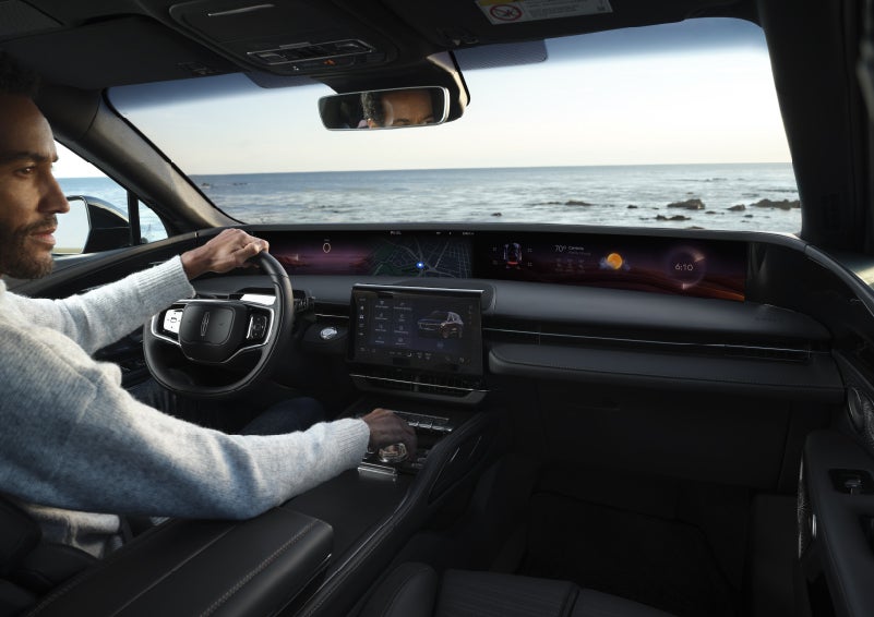 A driver of a parked 2026 Lincoln Nautilus® SUV takes a relaxing moment at a seaside overlook while inside his Nautilus. | Irwin Lincoln in Freehold NJ