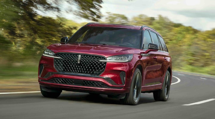 A 2027 Lincoln Aviator® SUV is being driven on a country road | Irwin Lincoln in Freehold NJ