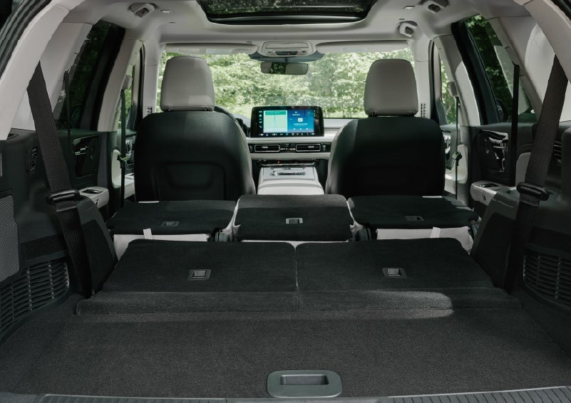 A rear to front view of the interior of a 2027 Lincoln Aviator® Black Label™ SUV shows the third and second rows folded flat | Irwin Lincoln in Freehold NJ
