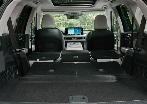 A rear to front view of the interior of a 2027 Lincoln Aviator® Black Label™ SUV shows the third and second rows folded flat | Irwin Lincoln in Freehold NJ