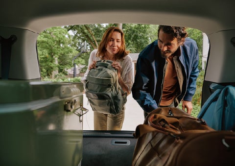 A couple loads luggage into the rear of a 2027 Lincoln Aviator® Black Label™ SUV..e 202 | Irwin Lincoln in Freehold NJ