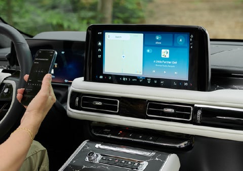 A person pairs thier phone with the center touchscreen of a 2027 Lincoln Aviator® Black Label™ SUV | Irwin Lincoln in Freehold NJ